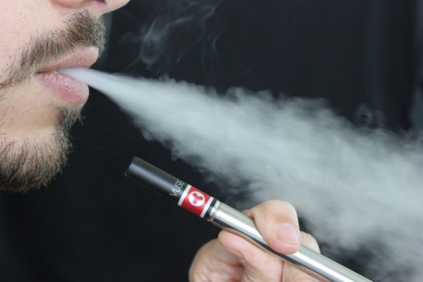 closeup-exhaling-vape-smoke Closeup of man exhaling vape cloud smoke